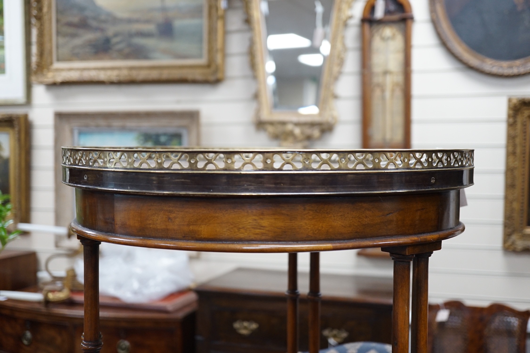 A leather topped mahogany occasional table with brass gallery, diameter 46cm *Please note the sale commences at 9am.